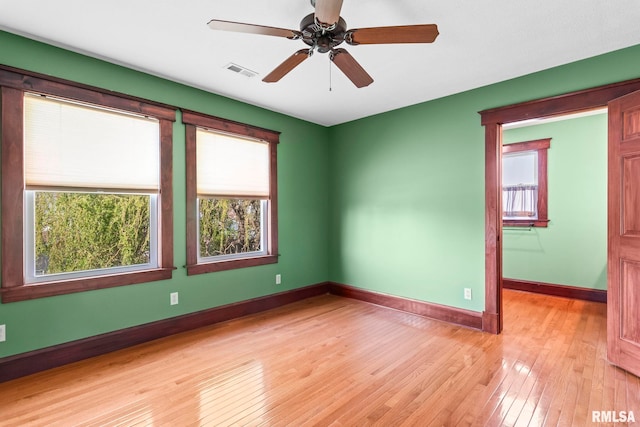 101 E Lester St, Williamsville, IL 62693 - empty room with light wood-type flooring, baseboards, a ceiling fan, and visible vents
