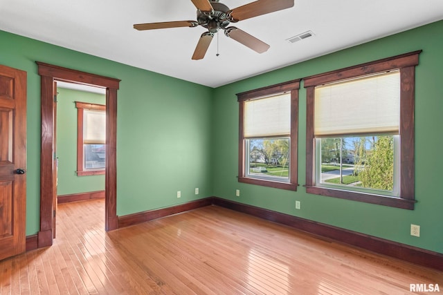 101 E Lester St, Williamsville, IL 62693 - empty room featuring light wood-style flooring, visible vents, a ceiling fan, and baseboards