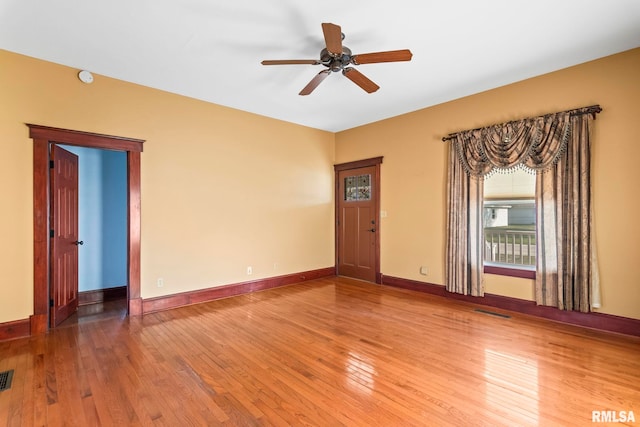 101 E Lester St, Williamsville, IL 62693 - unfurnished room with hardwood / wood-style flooring, baseboards, a ceiling fan, and visible vents