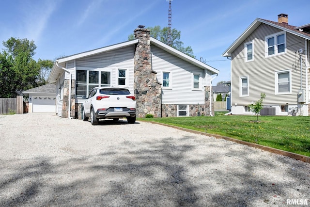 view of side of property with cooling unit, a lawn, and a chimney