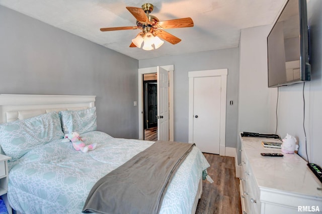 bedroom with a ceiling fan and wood finished floors