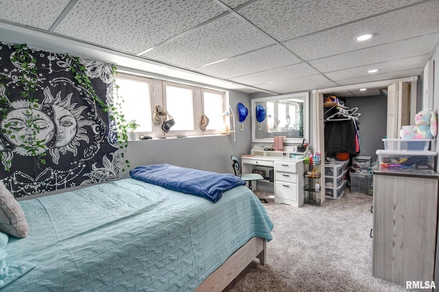 bedroom featuring a closet, a spacious closet, and light colored carpet