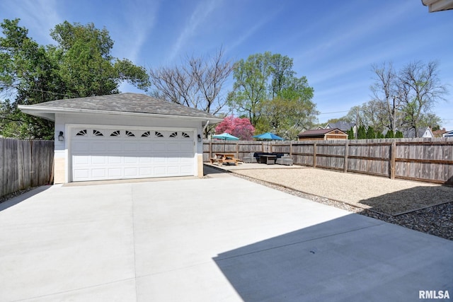 detached garage featuring fence