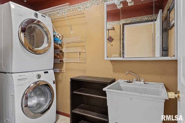 clothes washing area featuring stacked washer and dryer, laundry area, and a sink