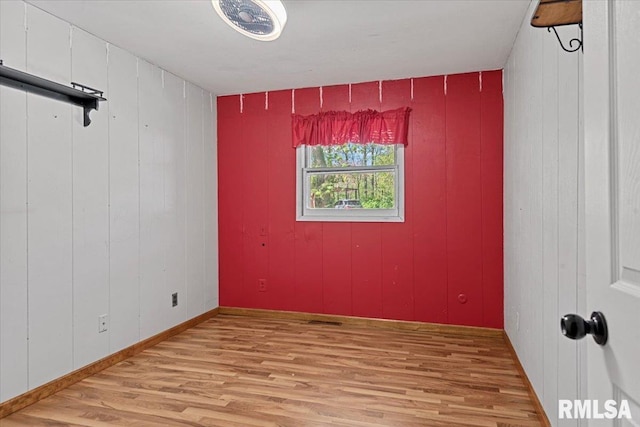 unfurnished room with light wood-style floors and visible vents