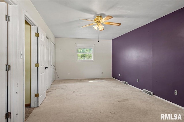 unfurnished bedroom featuring baseboards, visible vents, and carpet floors