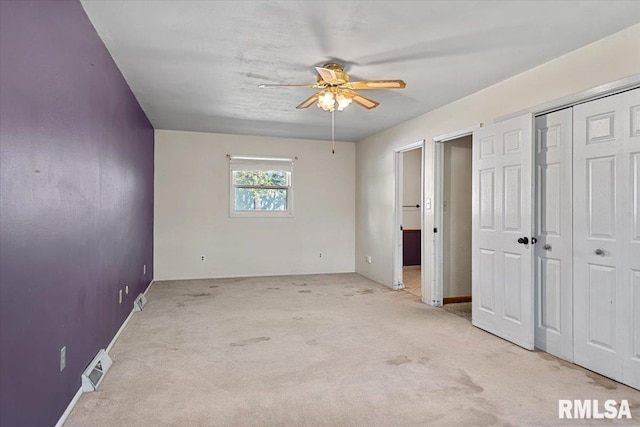 unfurnished bedroom featuring a ceiling fan, carpet flooring, and visible vents