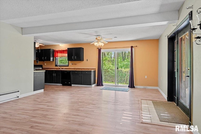 unfurnished living room with light wood-style floors, a sink, baseboards, a ceiling fan, and a textured ceiling