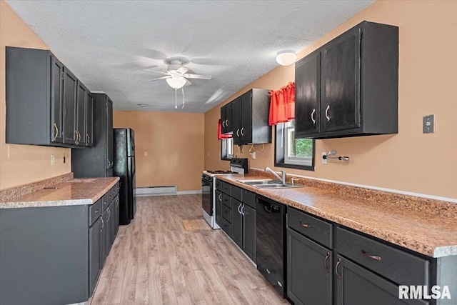 kitchen featuring light wood finished floors, a sink, black appliances, a ceiling fan, and a textured ceiling