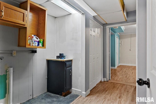 interior space featuring baseboards and light wood-style flooring
