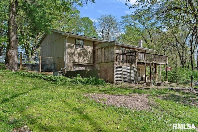 view of outbuilding featuring fence