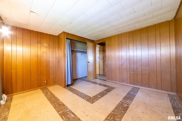 1620 N 703rd Ln, Liberty, IL 62347 - unfurnished bedroom with tile patterned floors, wood walls, and a closet