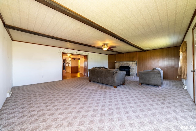 1620 N 703rd Ln, Liberty, IL 62347 - carpeted living area with a stone fireplace, wood walls, ornamental molding, and ceiling fan