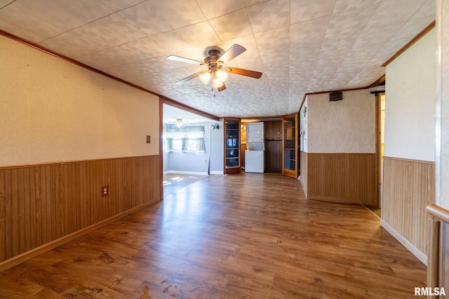 1620 N 703rd Ln, Liberty, IL 62347 - unfurnished room featuring wood finished floors, ceiling fan, a wainscoted wall, wood walls, and ornamental molding