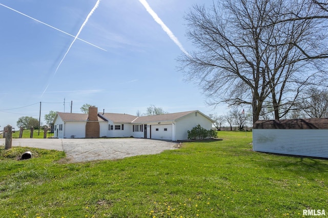 1620 N 703rd Ln, Liberty, IL 62347 - view of front facade with a front lawn, a storage shed, driveway, an outbuilding, and a garage