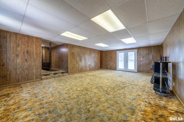 1620 N 703rd Ln, Liberty, IL 62347 - unfurnished living room featuring a paneled ceiling, carpet flooring, and wood walls