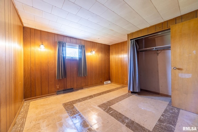 1620 N 703rd Ln, Liberty, IL 62347 - unfurnished bedroom featuring a closet, visible vents, wood walls, and baseboards