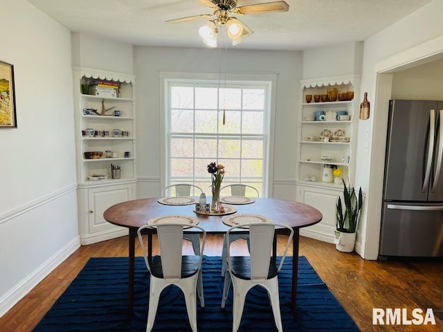 dining area featuring baseboards, wood finished floors, and ceiling fan