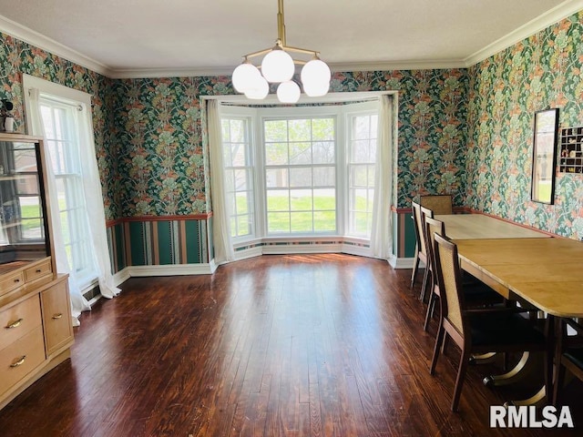 dining room featuring dark wood-type flooring, wallpapered walls, and ornamental molding