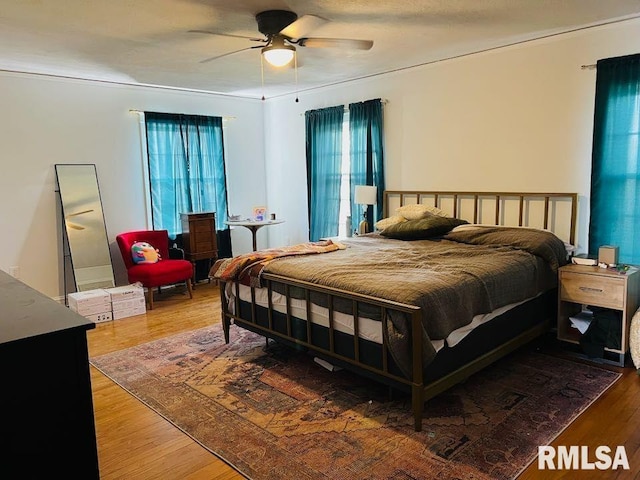 bedroom with wood finished floors and ceiling fan