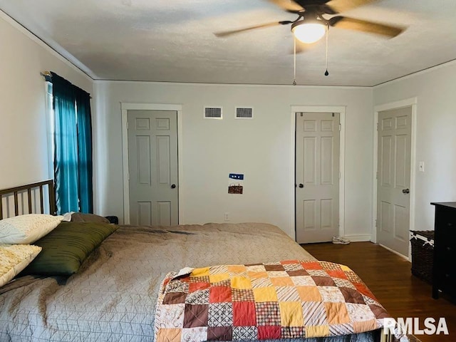 bedroom with dark wood-type flooring, visible vents, and ceiling fan