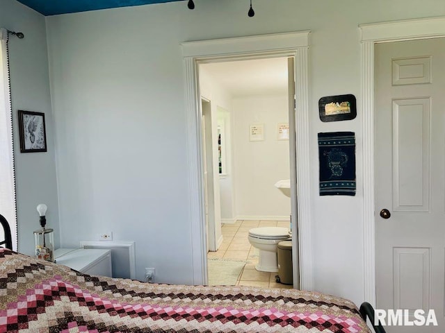 bedroom featuring connected bathroom and tile patterned floors