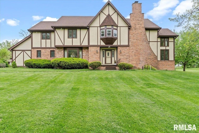 view of front of house featuring a chimney, stucco siding, and brick siding