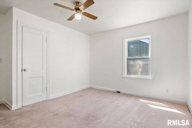 empty room featuring baseboards, carpet floors, and ceiling fan