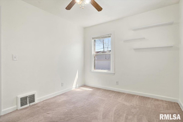 empty room with baseboards, visible vents, carpet, and ceiling fan