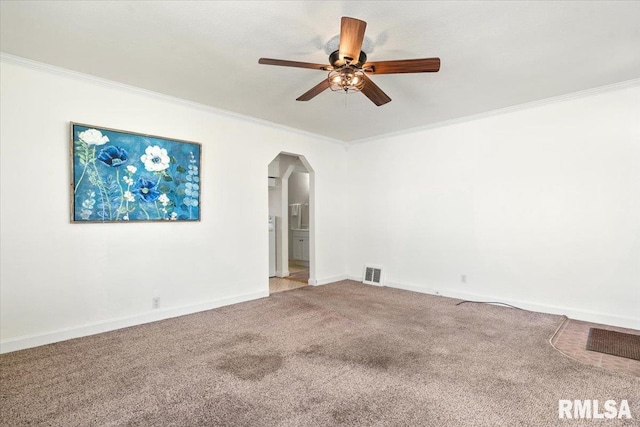 empty room with crown molding, carpet flooring, and visible vents