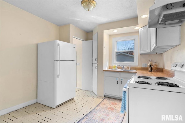 kitchen featuring ventilation hood, light countertops, a sink, white appliances, and baseboards
