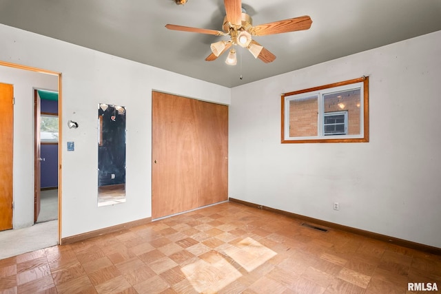 unfurnished bedroom featuring baseboards, visible vents, a ceiling fan, a closet, and light floors