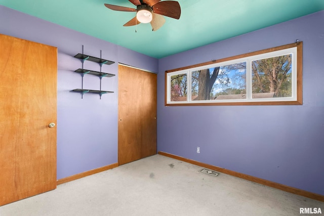 unfurnished bedroom with visible vents, baseboards, carpet, and a closet