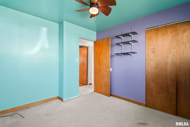 unfurnished bedroom with baseboards, carpet flooring, and a closet