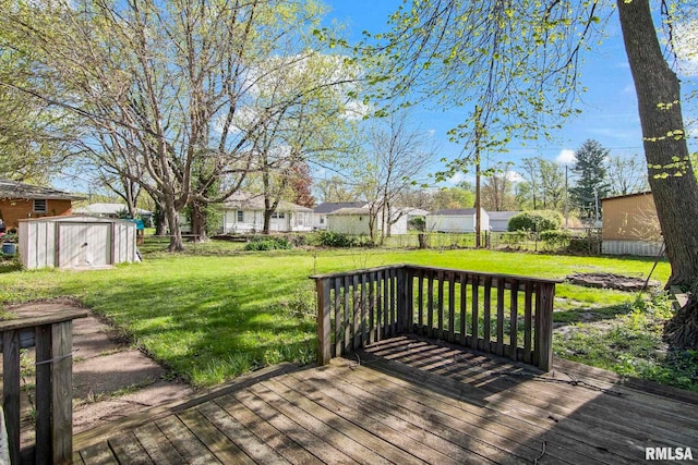 wooden deck featuring a yard, an outbuilding, and a shed