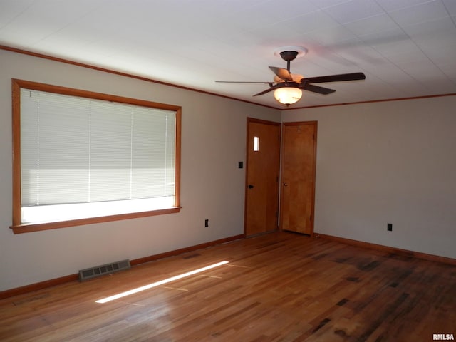 515 Franklin Ave, Galesburg, IL 61401 - unfurnished room with ceiling fan, wood finished floors, baseboards, ornamental molding, and healthy amount of natural light