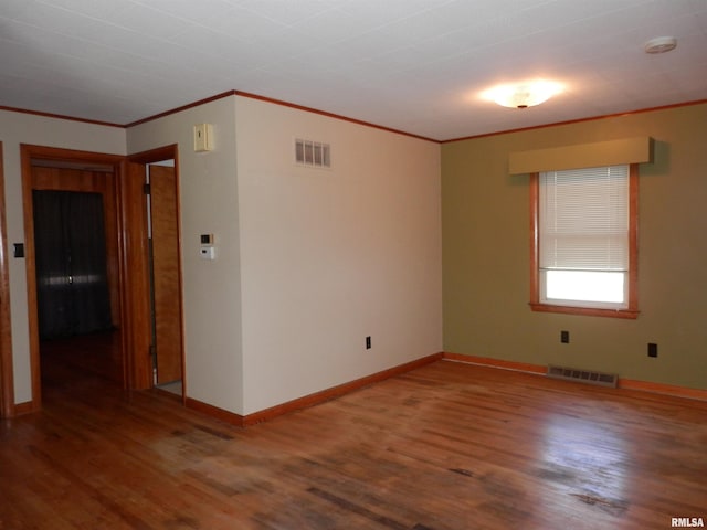 515 Franklin Ave, Galesburg, IL 61401 - empty room featuring wood finished floors, ornamental molding, baseboards, and a smoke detector