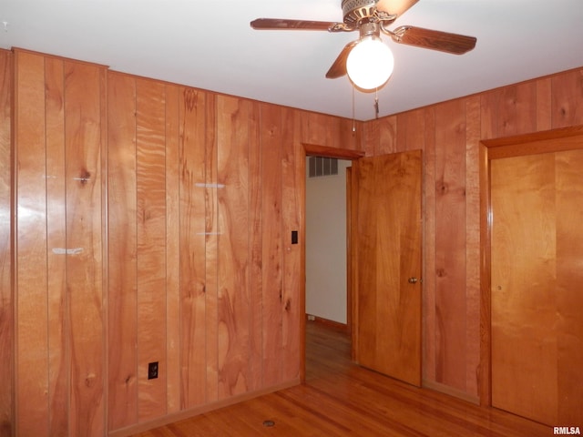 515 Franklin Ave, Galesburg, IL 61401 - spare room with wood walls, wood finished floors, and ceiling fan