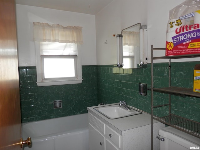 515 Franklin Ave, Galesburg, IL 61401 - full bath with vanity, a tub to relax in, toilet, tile walls, and a wainscoted wall
