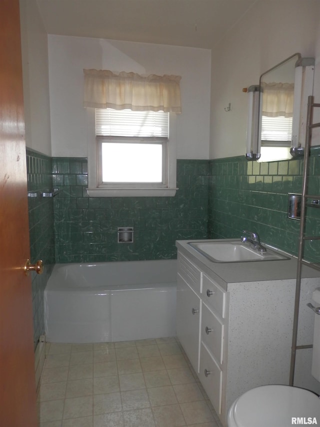 515 Franklin Ave, Galesburg, IL 61401 - full bath featuring vanity, a tub to relax in, toilet, wainscoting, and tile walls