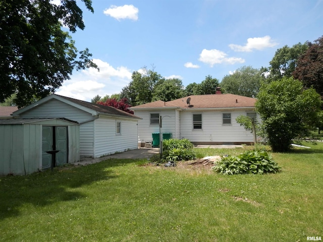 515 Franklin Ave, Galesburg, IL 61401 - rear view of property with a yard, a patio area, and a chimney