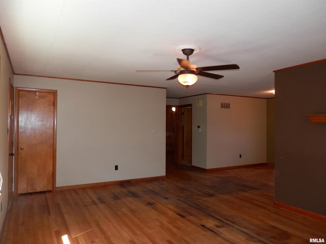 515 Franklin Ave, Galesburg, IL 61401 - spare room with a ceiling fan, baseboards, wood finished floors, and crown molding