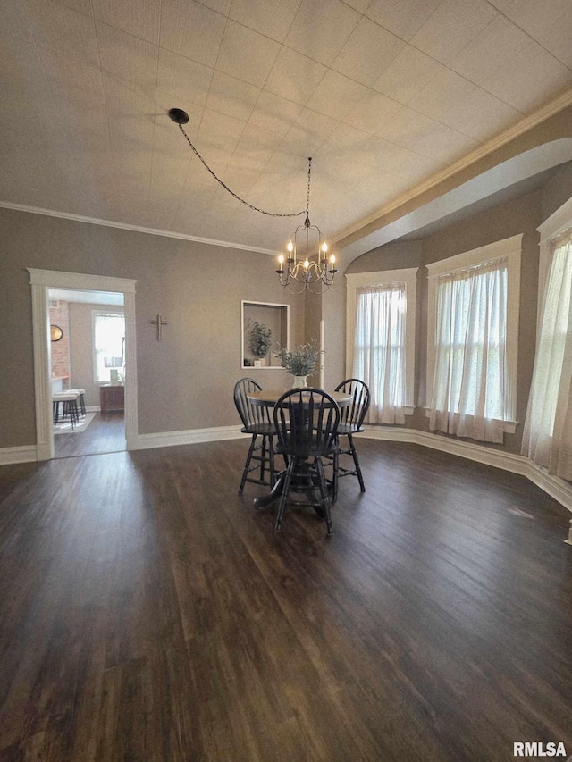 419 S 16th St, Quincy, IL 62301 - dining space with dark wood finished floors, ornamental molding, baseboards, and a notable chandelier
