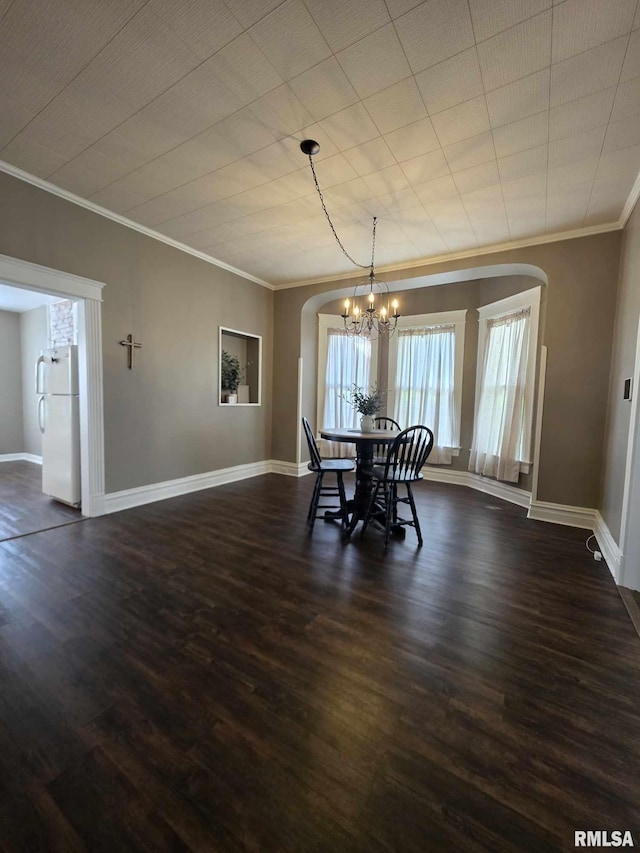 419 S 16th St, Quincy, IL 62301 - dining room with baseboards, arched walkways, ornamental molding, and dark wood finished floors