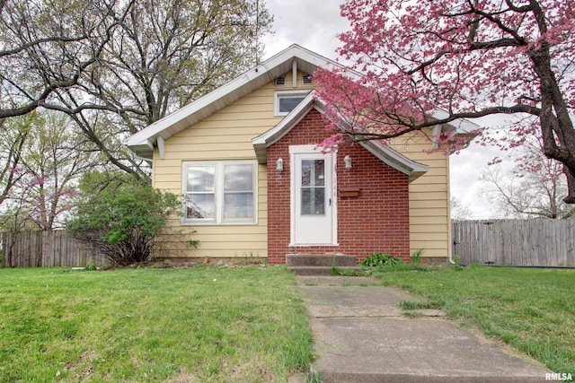 344 S State Rd, Mendon, IL 62351 - bungalow-style house with fence, entry steps, a front yard, and brick siding