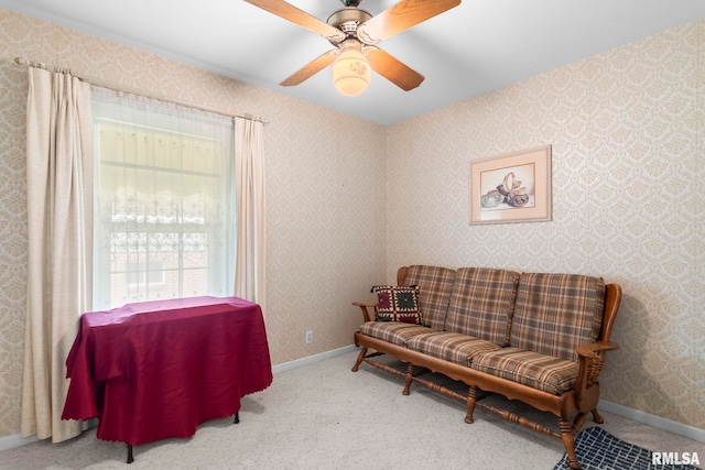 sitting room featuring carpet floors, ceiling fan, and baseboards