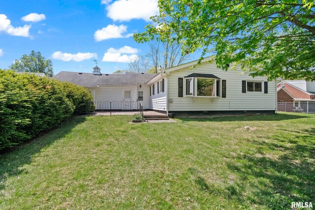 back of house with a yard, fence, and a patio area