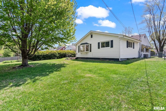 exterior space featuring fence and a yard