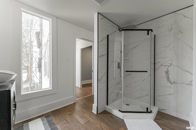 203 Oglesby Ave, Lincoln, IL 62656 - bathroom with visible vents, wood finished floors, a marble finish shower, and a healthy amount of sunlight