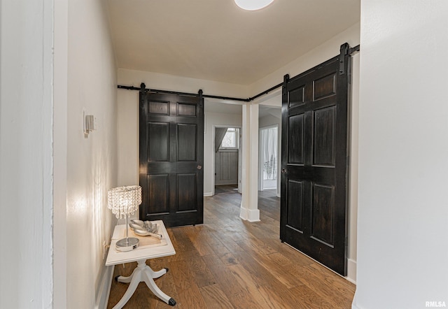 203 Oglesby Ave, Lincoln, IL 62656 - interior space featuring a barn door, baseboards, and dark wood-style flooring